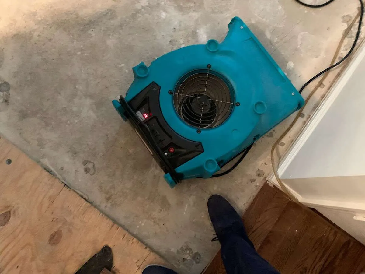 Air mover drying subfloor during Commercial Water Damage Restoration in Spring Ridge